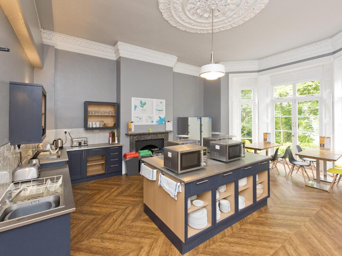 a large kitchen with a counter top with a microwave at YHA Bath in Bath