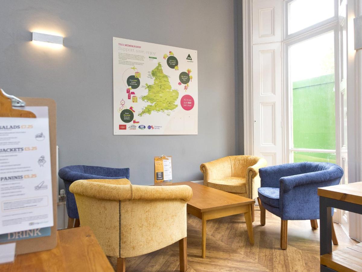 a waiting room with chairs and a table at YHA Bath in Bath