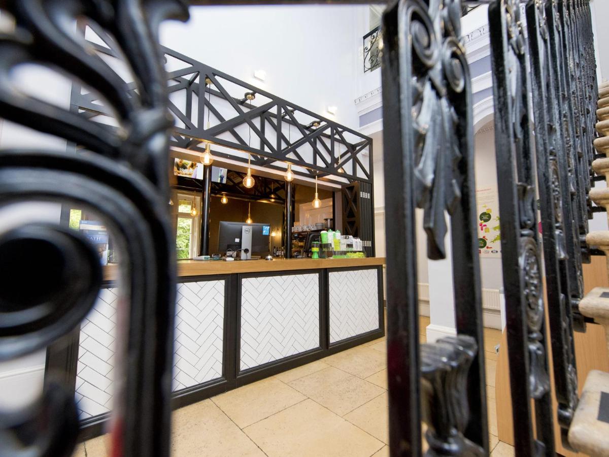 a view of a restaurant through a wrought iron gate at YHA Bath in Bath